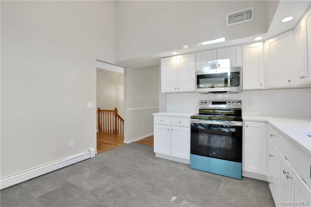 2 Requa Street Briarcliff Manor, NY 10510 - Photo 9 of 36 a kitchen with stainless steel appliances a stove microwave and sink