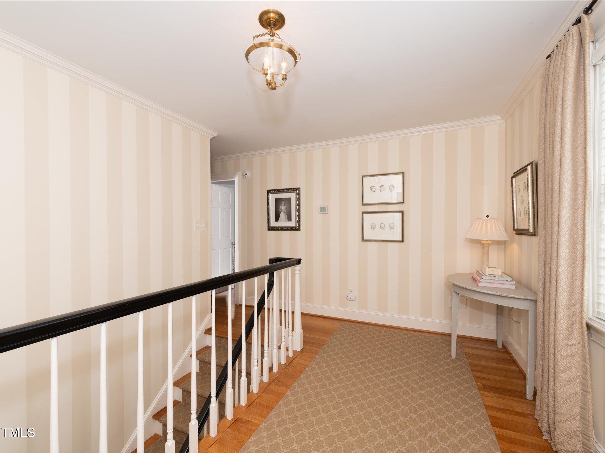 2622 Dover Road Raleigh, NC 27608 - Photo 34 of 72 a view of a hallway with wooden floor and staircase