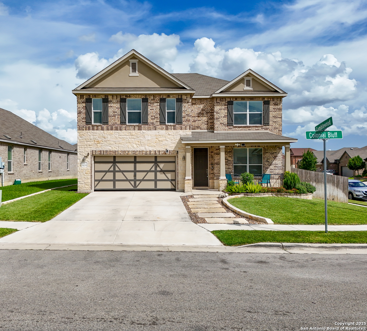 a front view of a house with a yard and garage