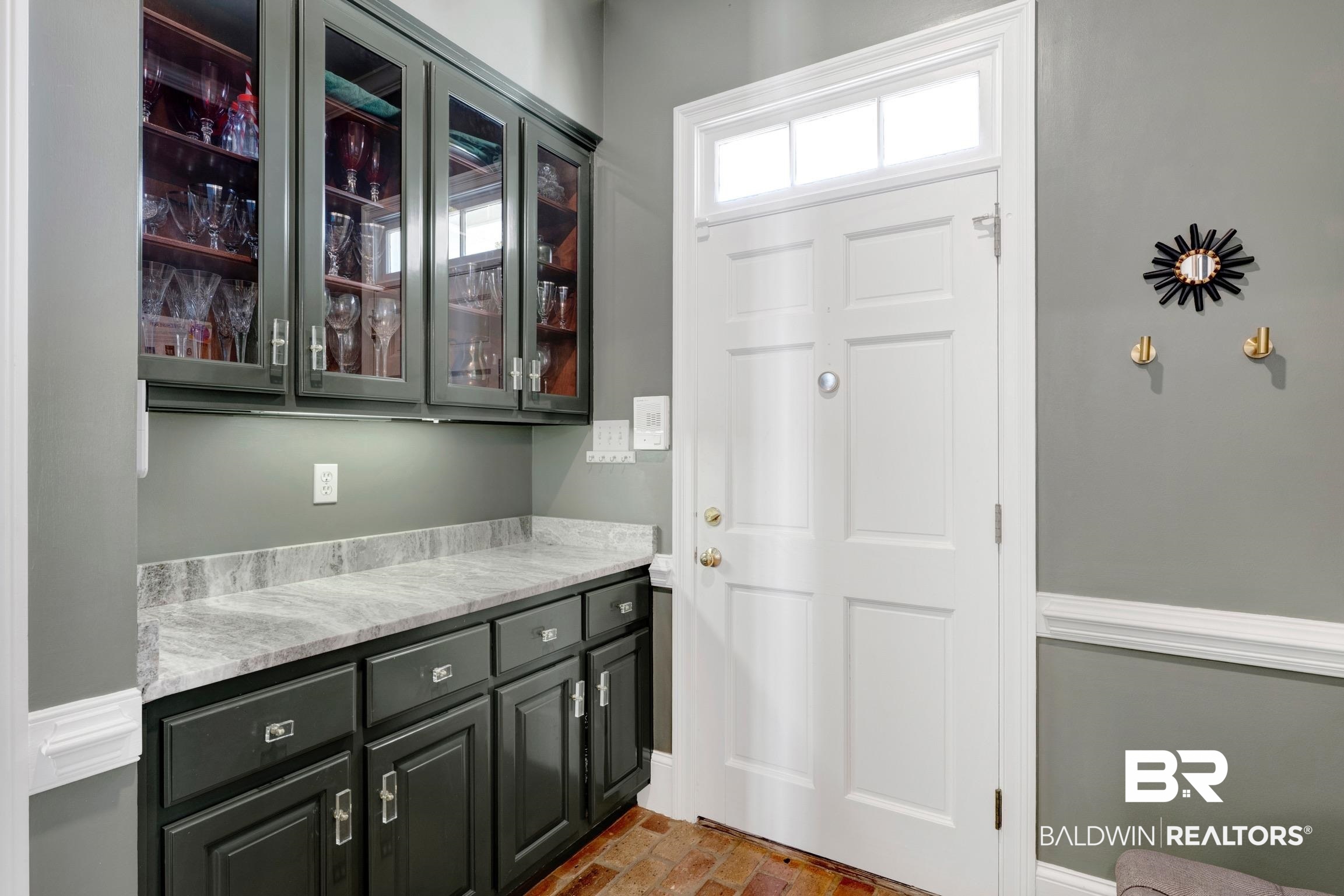 4 Savannah Court Mobile, AL 36608 - Photo 10 of 32 Bar area with glass fronted cabinets, brick flooring, and light stone counters