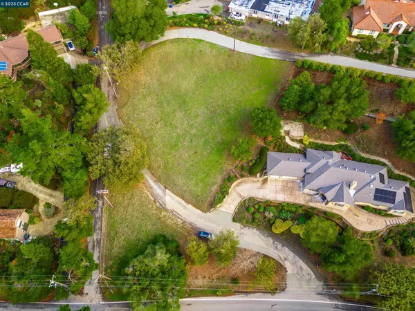 an aerial view of residential houses with outdoor space and swimming pool