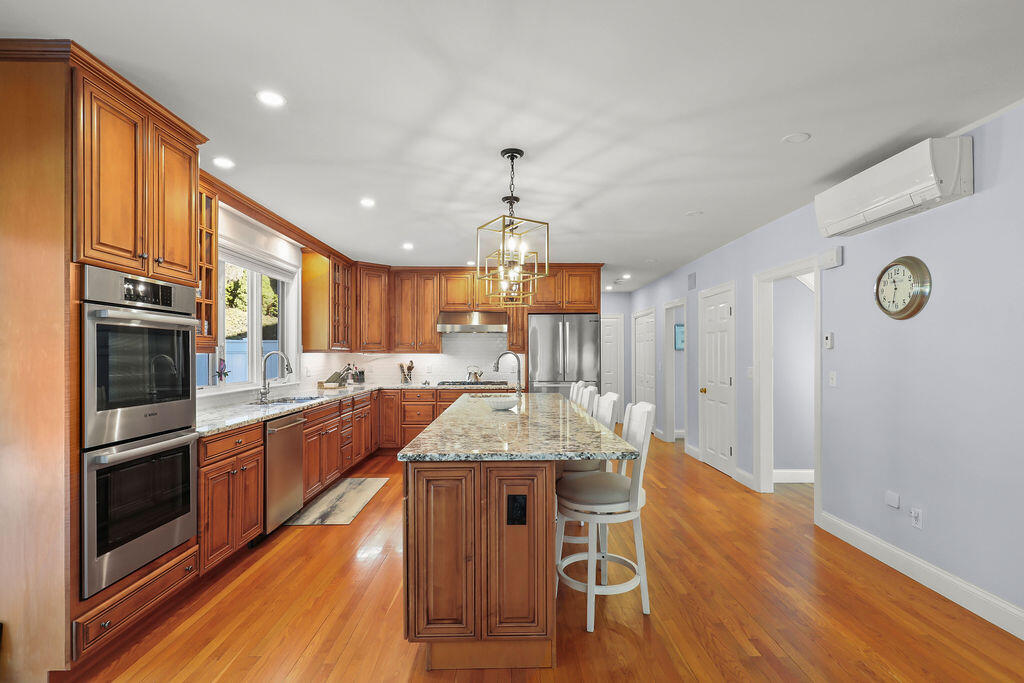 5 Fairfield Drive East Sandwich, MA 02537 - Photo 17 of 72 a large kitchen with granite countertop center island wooden floor stainless steel appliances and cabinets