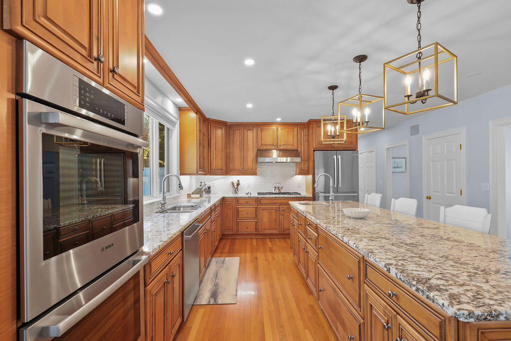 5 Fairfield Drive East Sandwich, MA 02537 - Photo 18 of 72 a view of a kitchen with kitchen island granite countertop wooden floor and stainless steel appliances