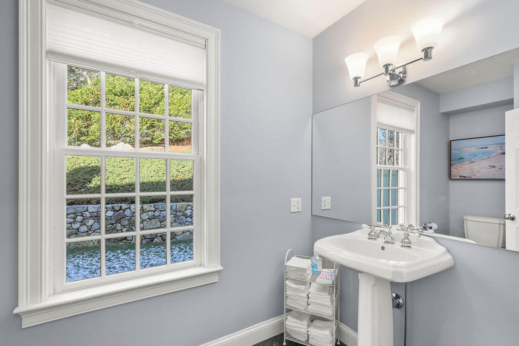 5 Fairfield Drive East Sandwich, MA 02537 - Photo 28 of 72 a bathroom with a sink a window and a mirror