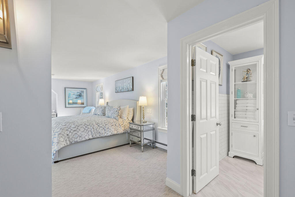 5 Fairfield Drive East Sandwich, MA 02537 - Photo 37 of 72 a bedroom with a bed and a mirror