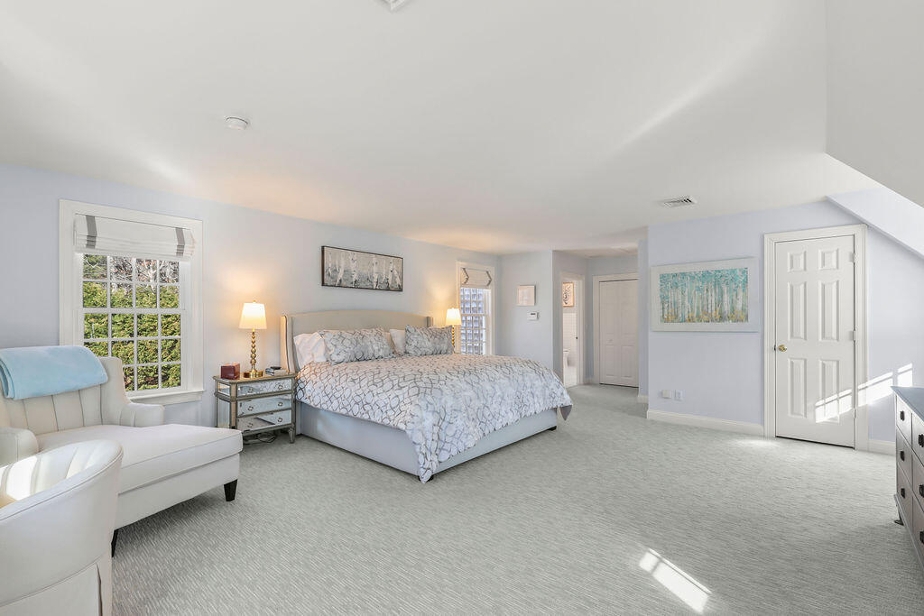 5 Fairfield Drive East Sandwich, MA 02537 - Photo 40 of 72 a spacious bedroom with a bed and glass window