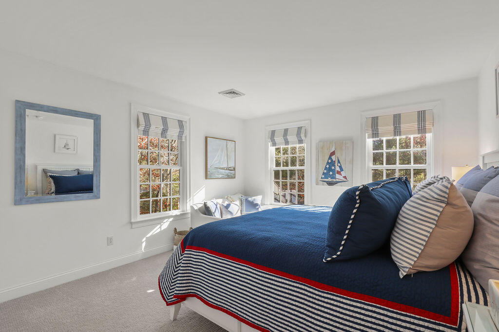 5 Fairfield Drive East Sandwich, MA 02537 - Photo 49 of 72 a bedroom with a bed lamp and a window