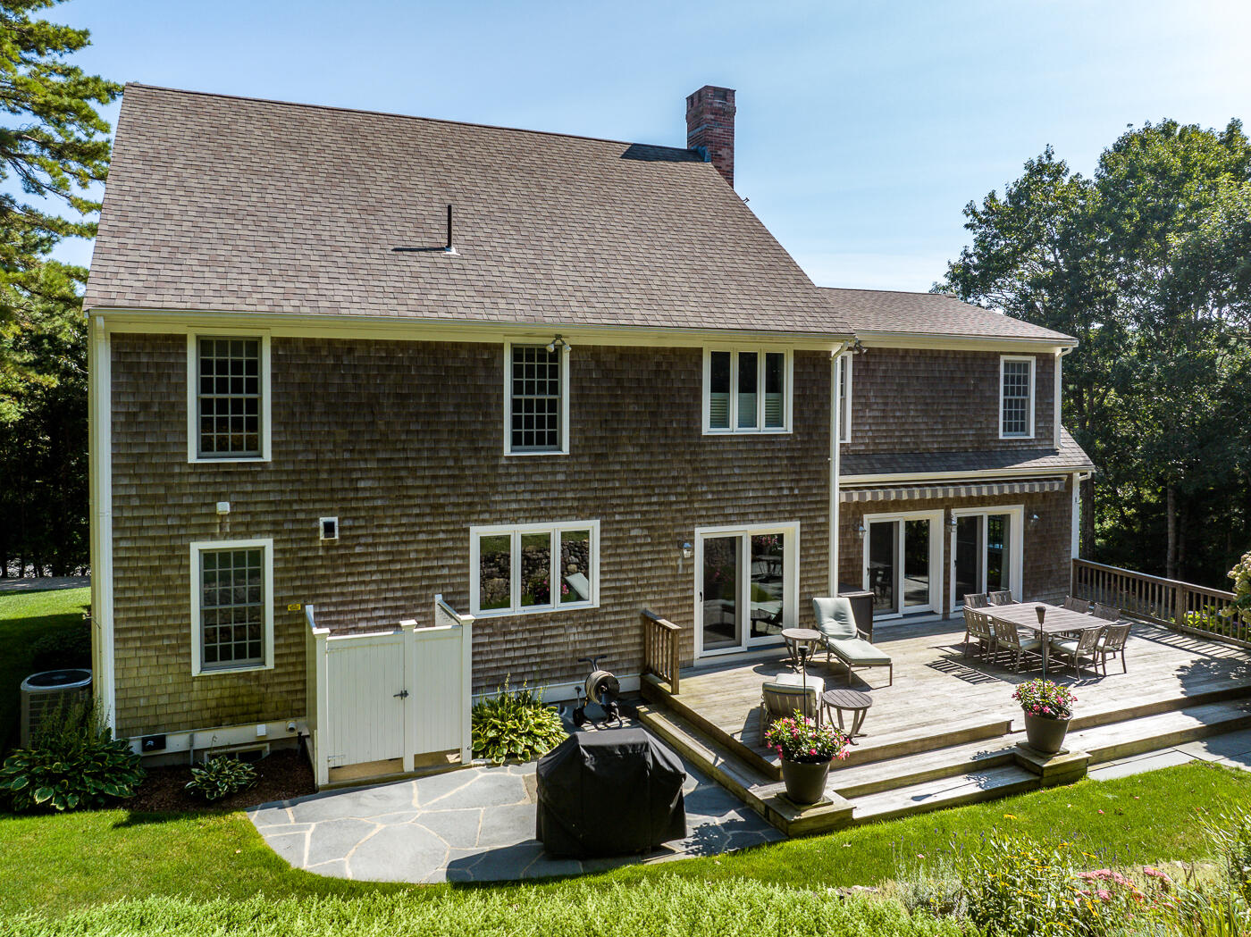 5 Fairfield Drive East Sandwich, MA 02537 - Photo 63 of 72 a front view of a house with a yard glass top table and chairs