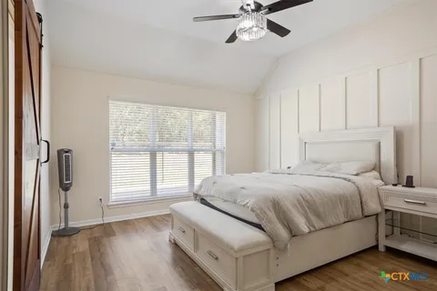 a bedroom with a bed and a window