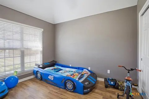 a bedroom with a bed and a window