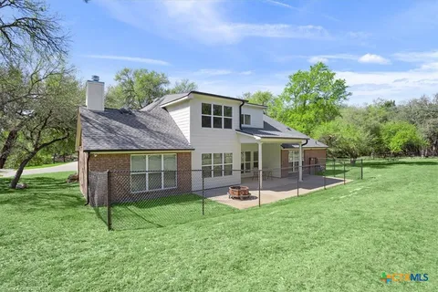 a view of a house with a yard and sitting area