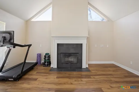 a room with a fireplace and wooden floor