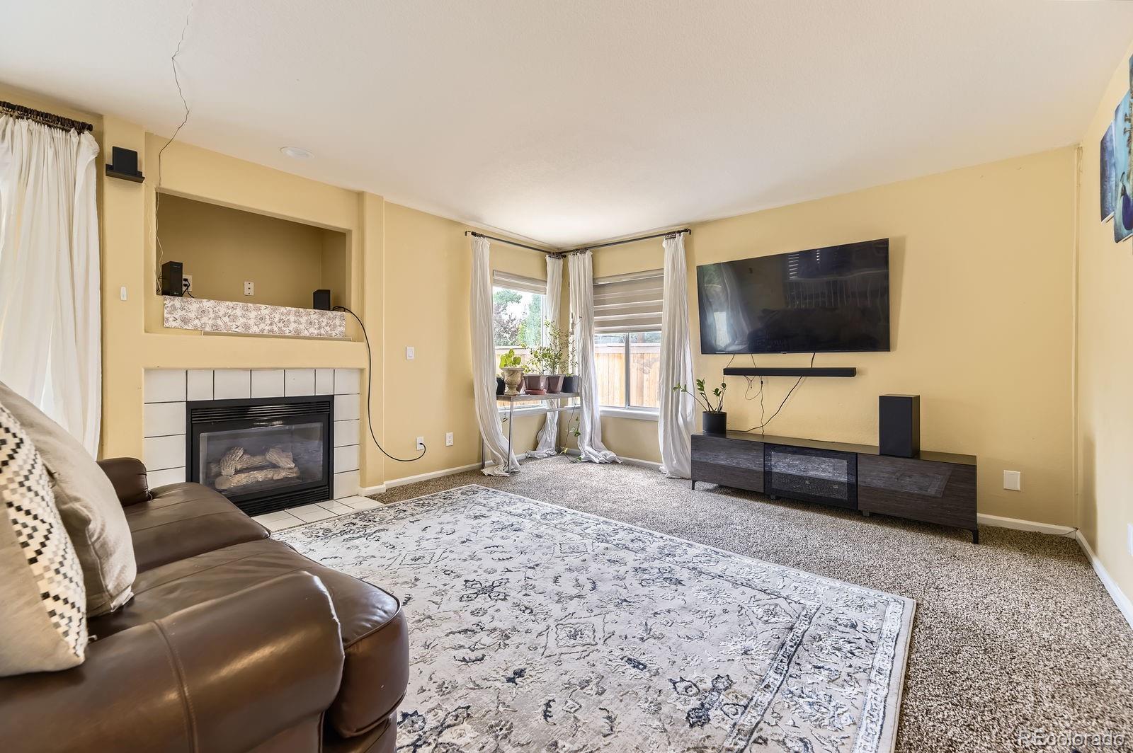 5329 Morning Glory Place Highlands Ranch, CO 80130 - Photo 12 of 28 a living room with furniture and a flat screen tv