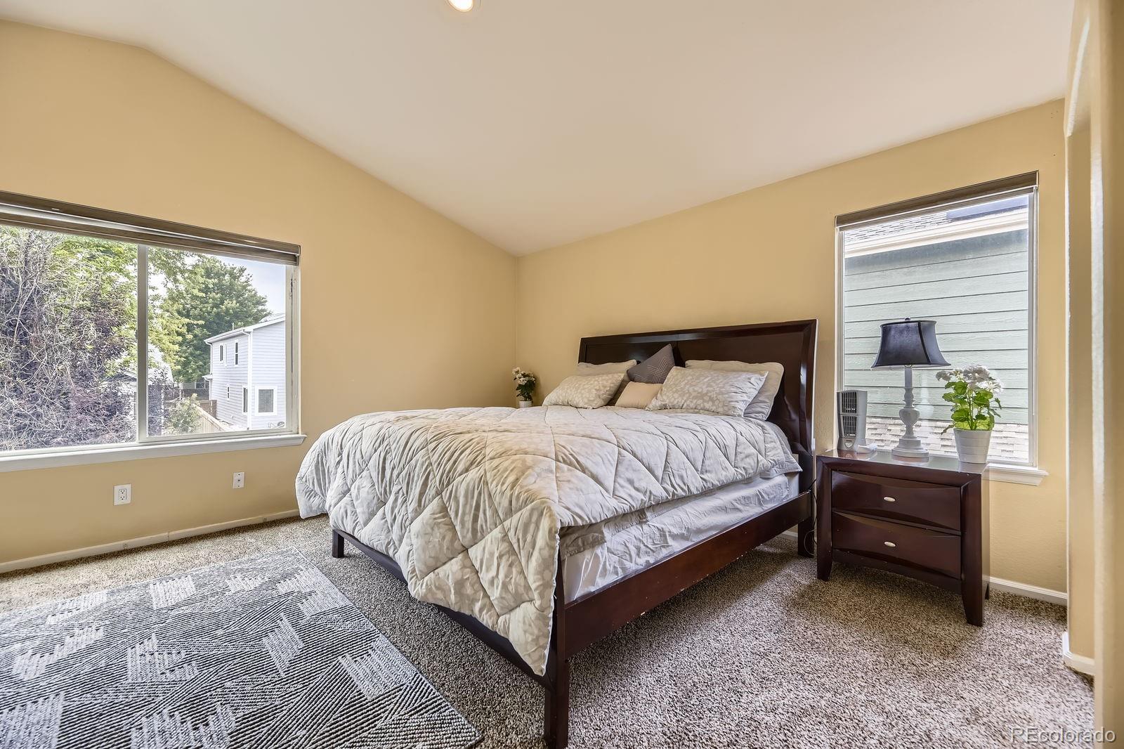 5329 Morning Glory Place Highlands Ranch, CO 80130 - Photo 14 of 28 a bed sitting in a bedroom next to a window