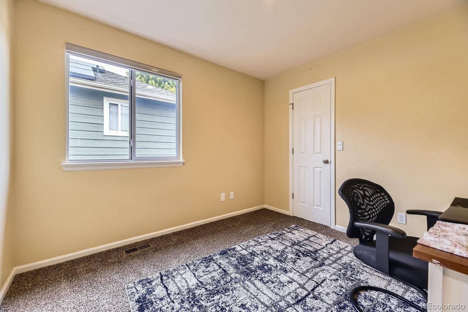 5329 Morning Glory Place Highlands Ranch, CO 80130 - Photo 18 of 28 a room with a chair and a window