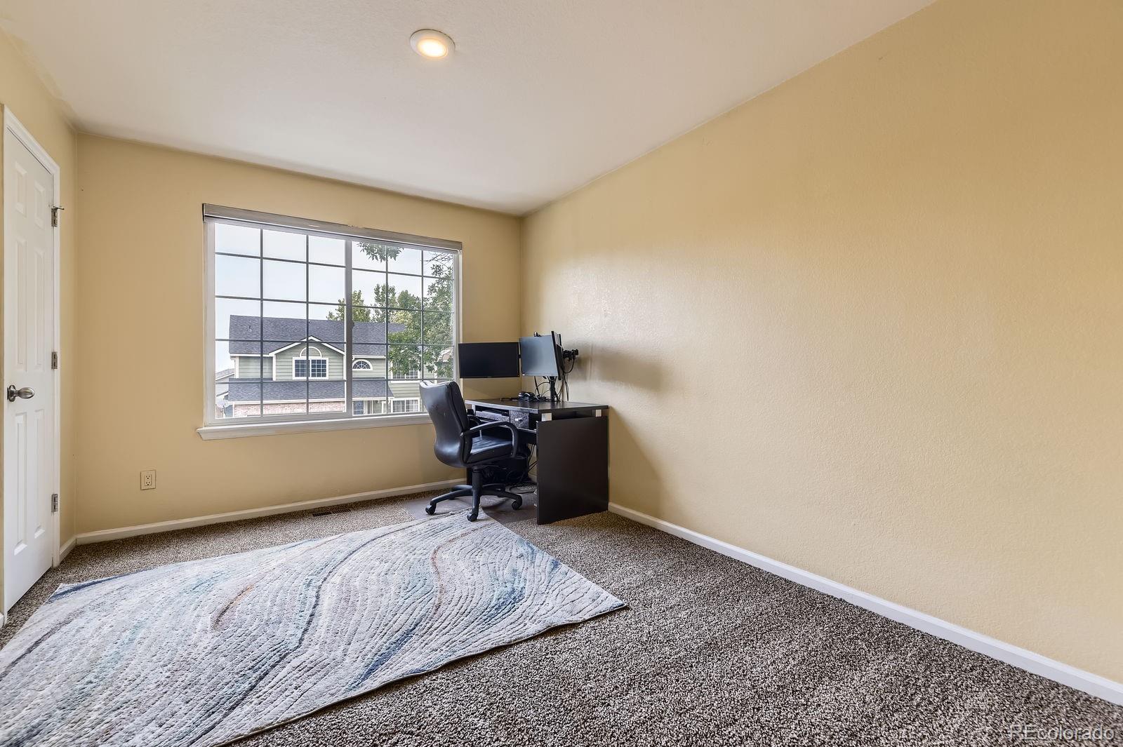 5329 Morning Glory Place Highlands Ranch, CO 80130 - Photo 19 of 28 a bedroom with a bed and a window