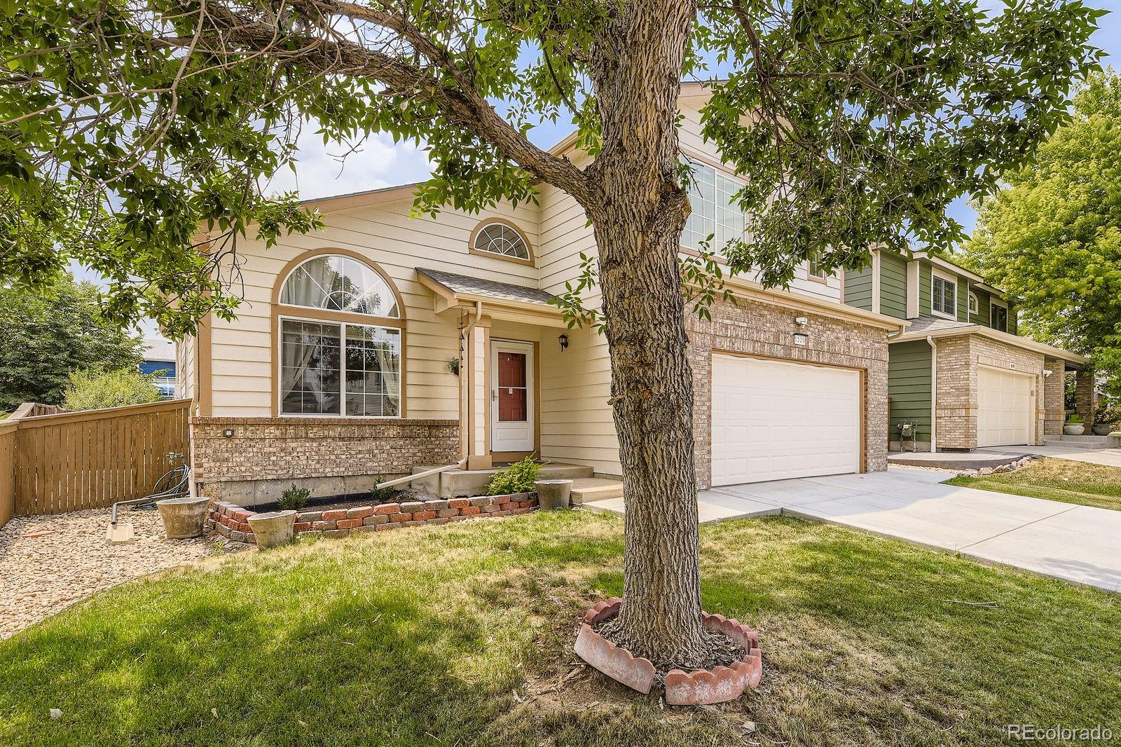 5329 Morning Glory Place Highlands Ranch, CO 80130 - Photo 2 of 28 a front view of a house with a yard