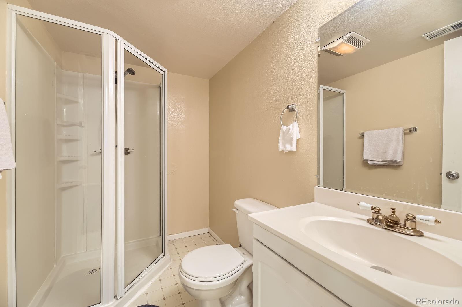 5329 Morning Glory Place Highlands Ranch, CO 80130 - Photo 23 of 28 a bathroom with a sink a toilet and shower