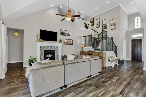 a living room with furniture a flat screen tv and a fireplace