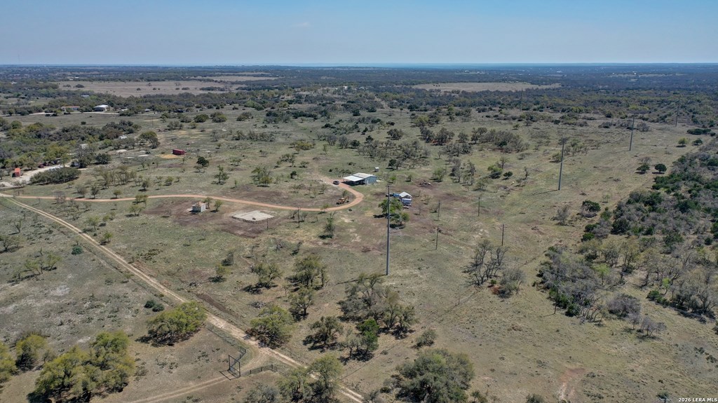 1443 Gina Road Harper, TX 78631 - Photo 41 of 49 a view of a dry yard with trees in the background