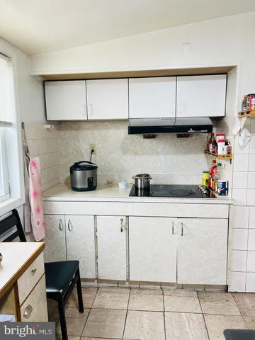 a view of a dining room with furniture and potted plant