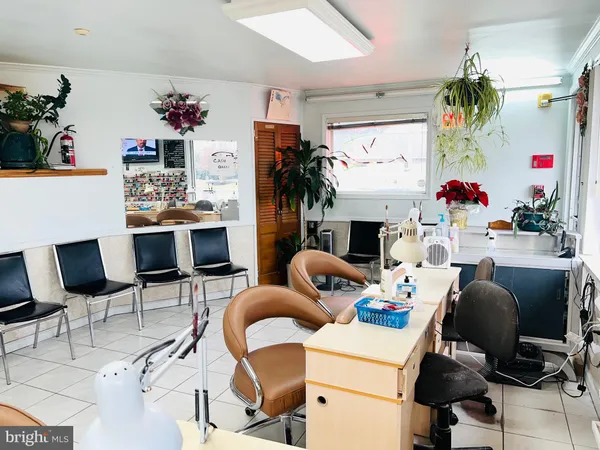 a work room with furniture a flat screen tv and a fireplace