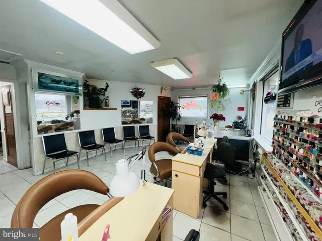 a outdoor kitchen with a kitchen island dining table and chairs
