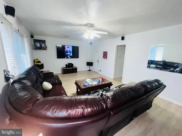 a living room with furniture and a mirror
