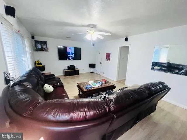 a living room with furniture and a mirror