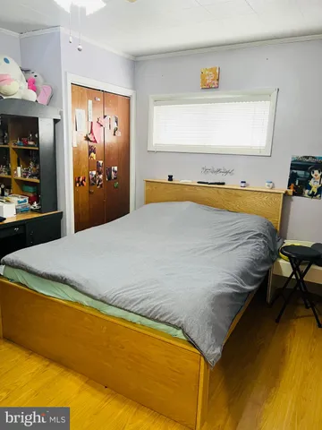 a bed sitting in a bedroom next to a window