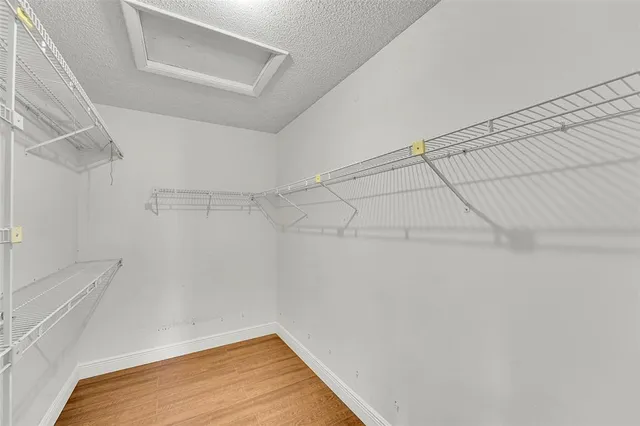 a view of walk in closet with empty racks