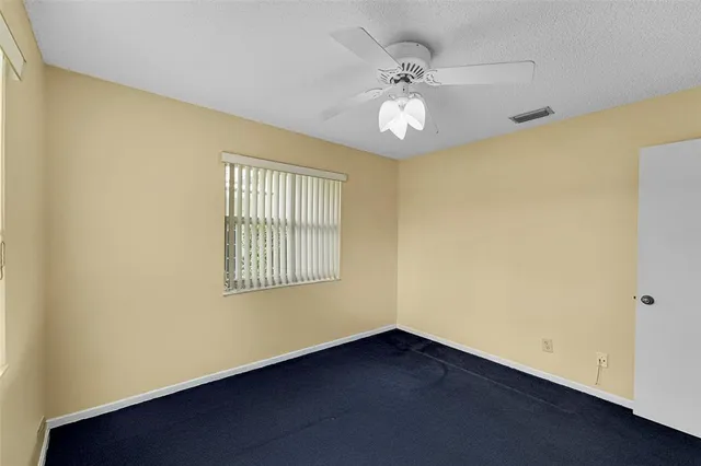 a view of an empty room with a fireplace and a large window