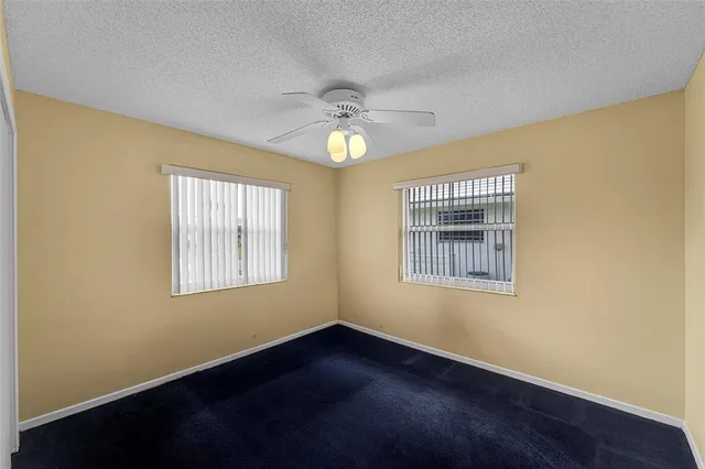 a view of a tennis ground with a big yard