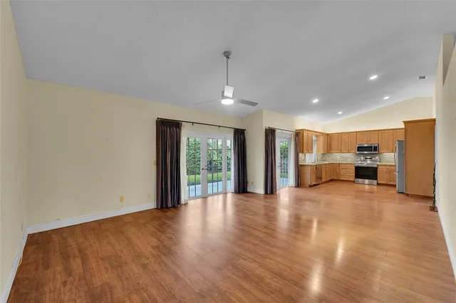 a kitchen with stainless steel appliances granite countertop a refrigerator stove and sink