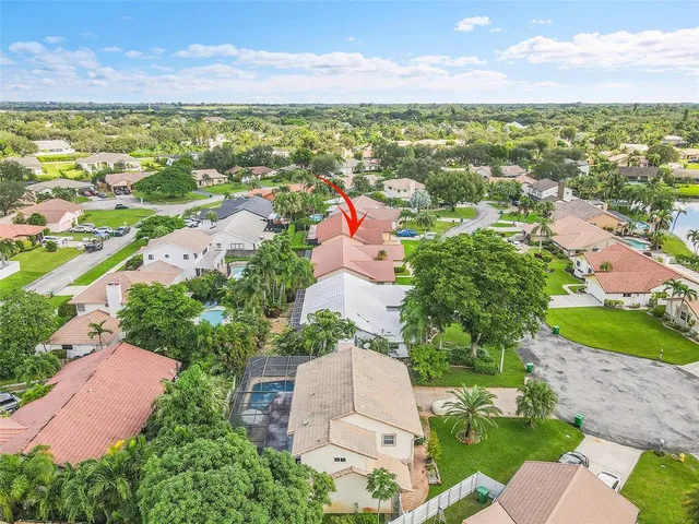 an aerial view of a house with a yard