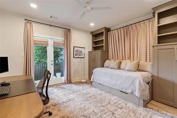 a bedroom with furniture a bed and a flat screen tv
