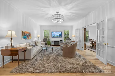 a living room with furniture a window and a table