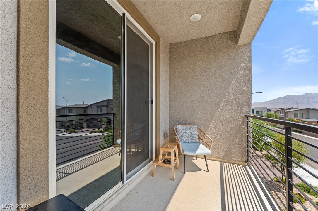 8879 Roadrunner Ravine Street Las Vegas, NV 89166 - Photo 20 of 39 An inviting balcony space provides serene outdoor relaxation with mountain and neighborhood views.