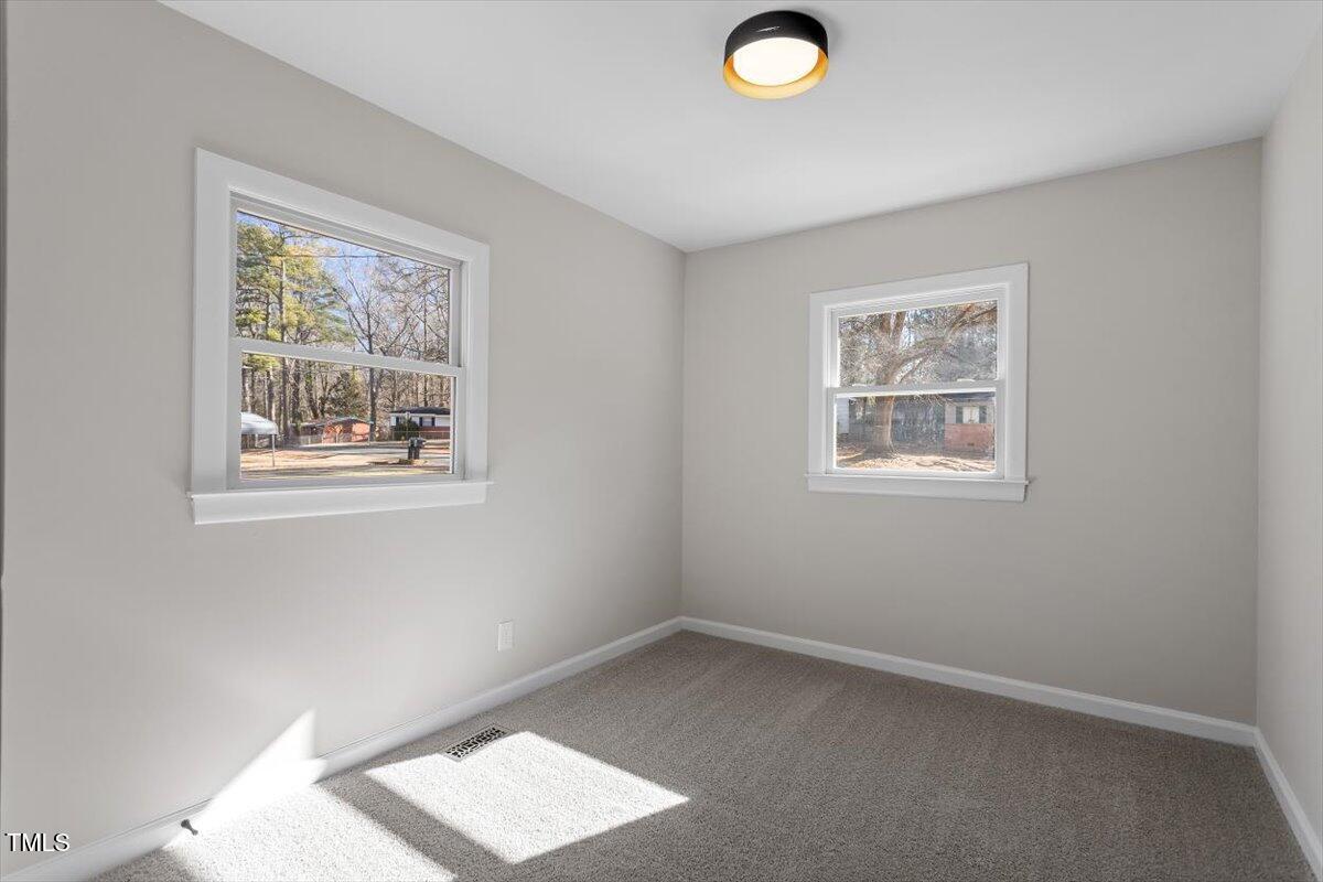 1404 Valley Road Garner, NC 27529 - Photo 16 of 29 an empty room with windows