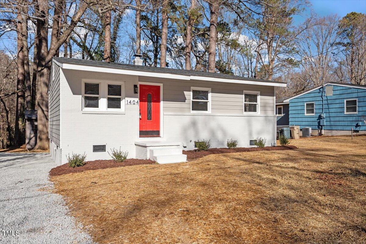 1404 Valley Road Garner, NC 27529 - Photo 23 of 29 a front view of a house with a yard and garage