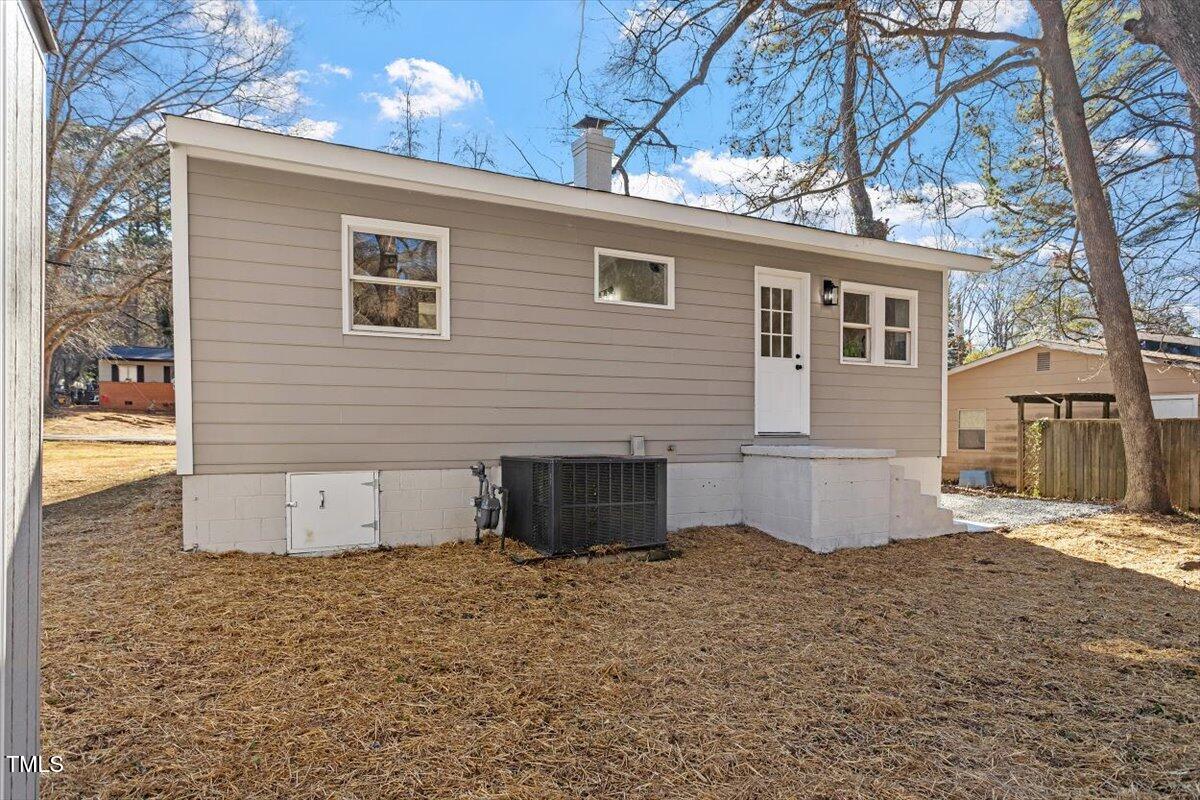 1404 Valley Road Garner, NC 27529 - Photo 27 of 29 a view of a house with backyard and a tree