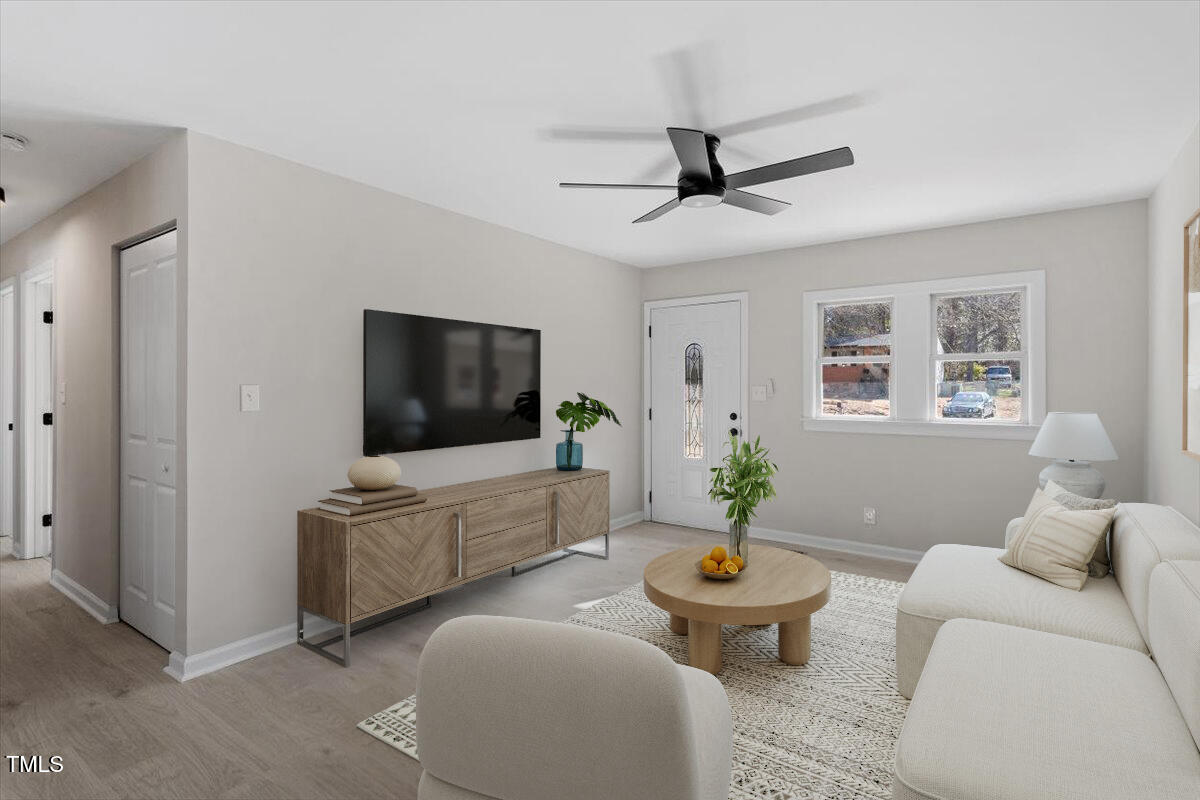 1404 Valley Road Garner, NC 27529 - Photo 5 of 29 a living room with furniture and a flat screen tv