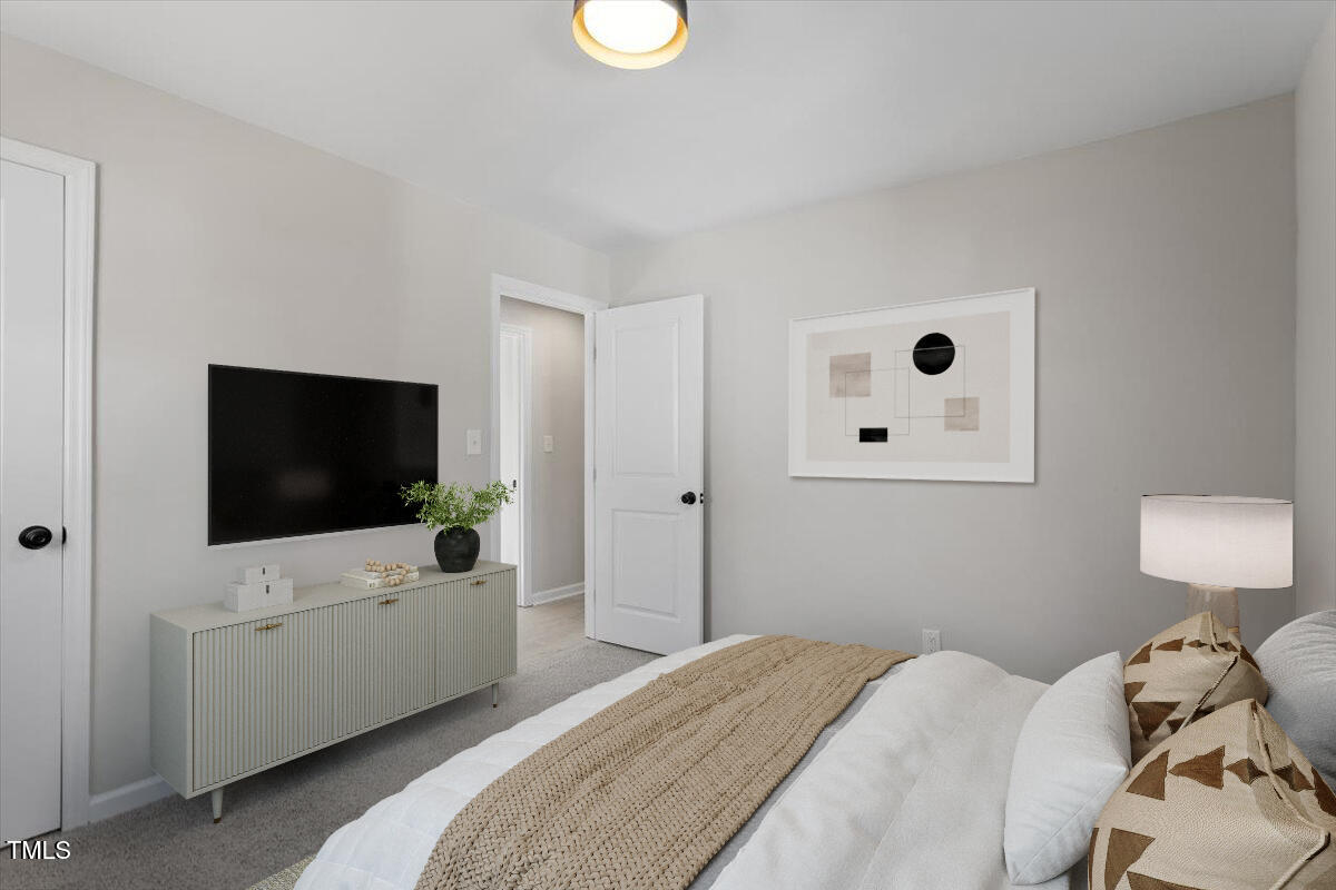 1404 Valley Road Garner, NC 27529 - Photo 7 of 29 a bedroom with a bed and a flat screen tv