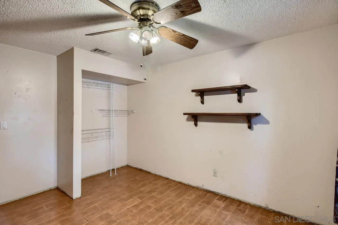 9572 Domer Road Santee, CA 92071 - Photo 21 of 28 an empty room with a ceiling fan and a window