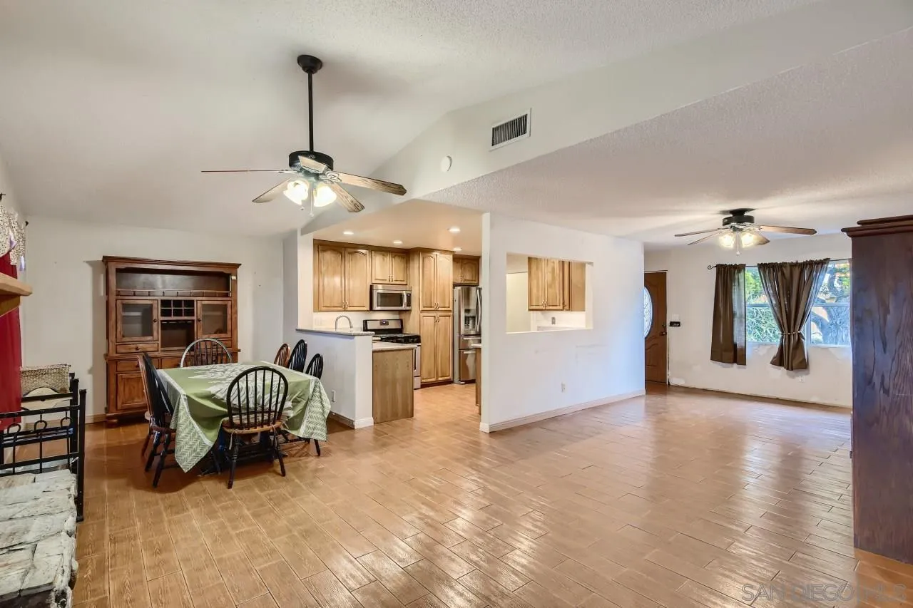 9572 Domer Road Santee, CA 92071 - Photo 6 of 28 a living room with furniture and a chandelier
