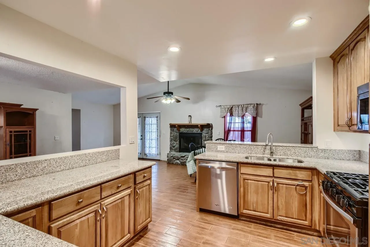 9572 Domer Road Santee, CA 92071 - Photo 10 of 28 a kitchen with stainless steel appliances granite countertop a sink stove and cabinets