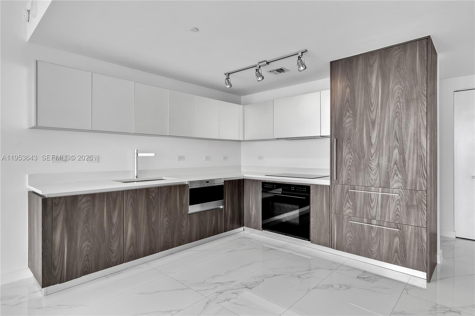 3131 Northeast 7th Avenue, Unit 3704 Miami, FL 33137 - Photo 16 of 61 a kitchen with stainless steel appliances a stove and a refrigerator