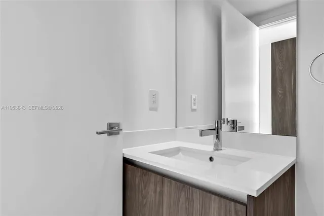 a spacious bathroom with a double vanity sink a mirror and a bathtub