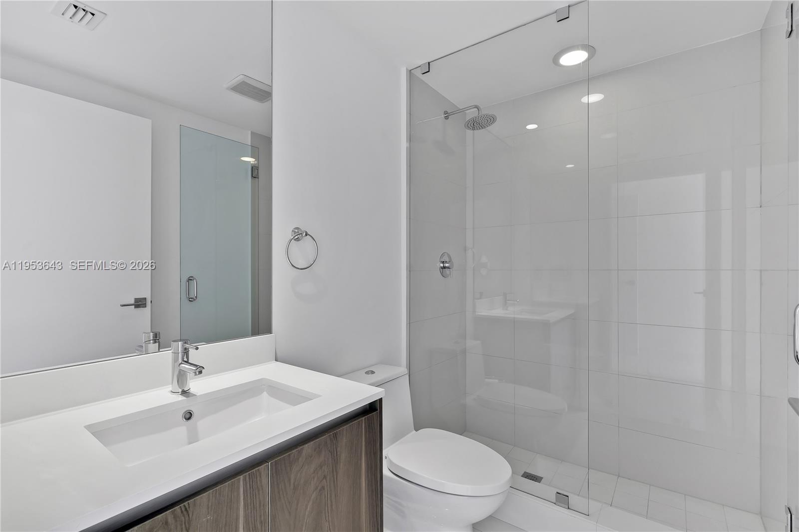 3131 Northeast 7th Avenue, Unit 3704 Miami, FL 33137 - Photo 39 of 61 a bathroom with a sink toilet a mirror and shower