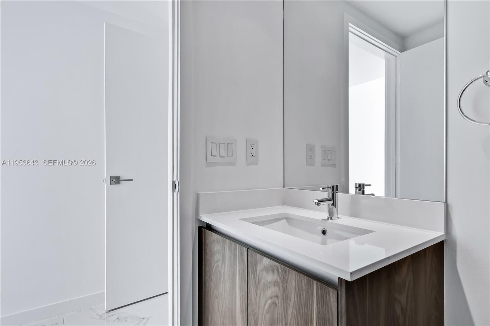 3131 Northeast 7th Avenue, Unit 3704 Miami, FL 33137 - Photo 40 of 61 a bathroom with a sink and a mirror